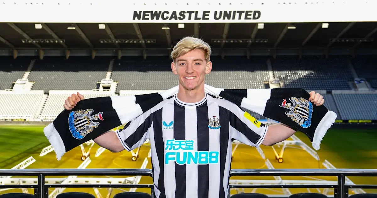 Anthony Gordon wearing a Newcastle United kit and holding a club scarf at St James' Park
