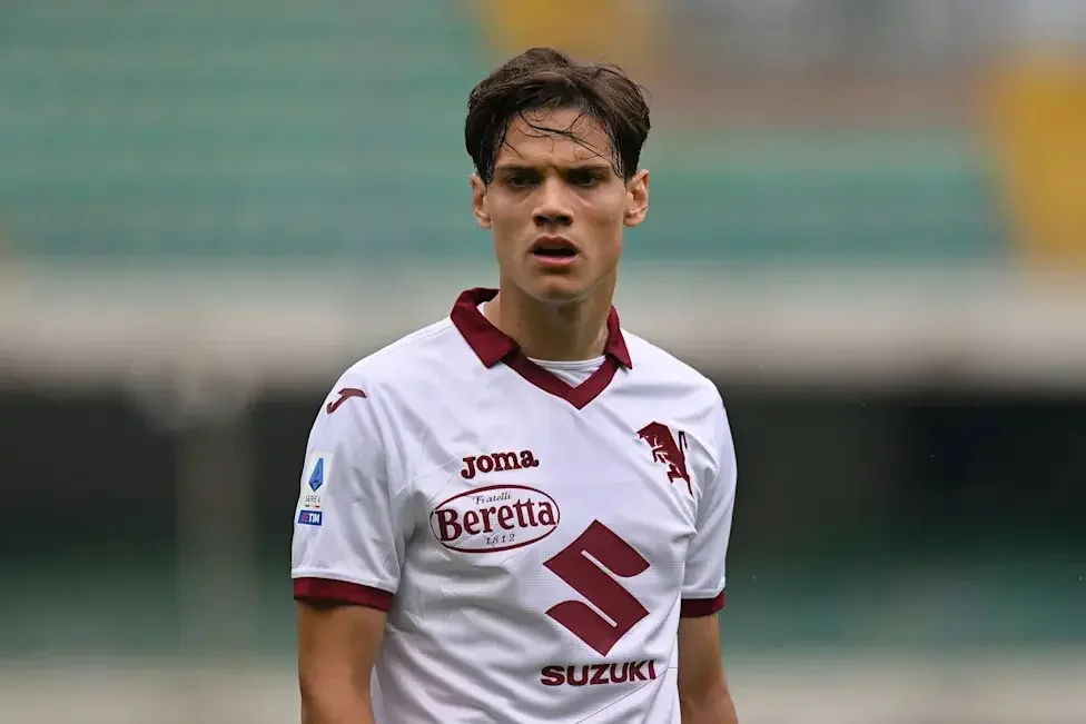 Samuele Ricci wearing a white Torino FC jersey with maroon trim during a Serie A match